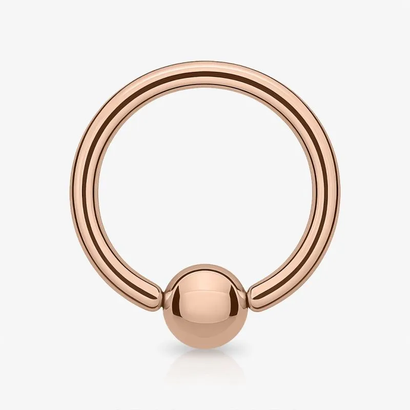 Piercing captive rosé em aço cirúrgico com bolinha rosé gold