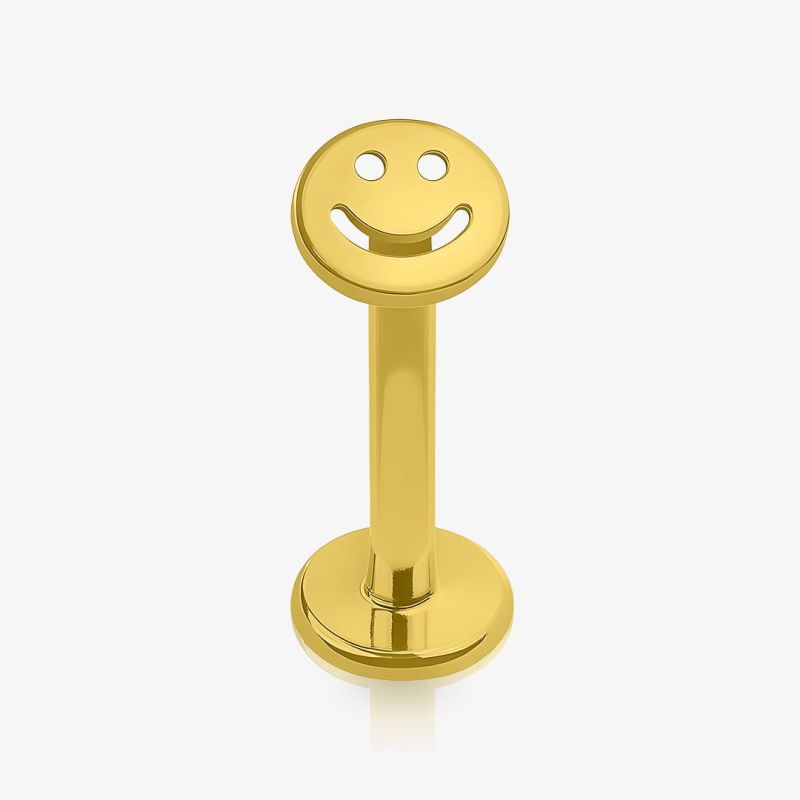 Piercing labret smile dourado em aço cirúrgico com design minimalista e símbolo de sorriso